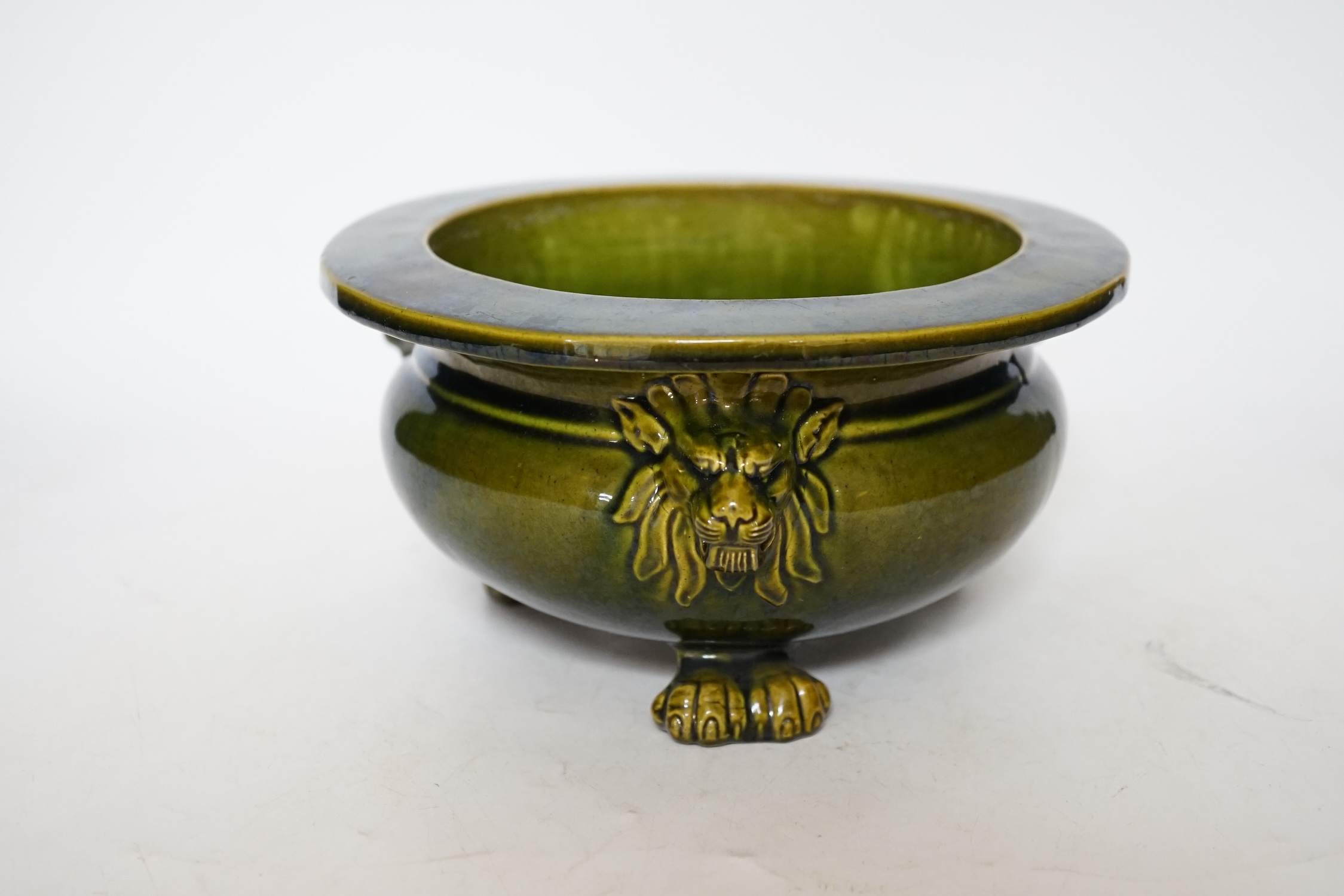 A green glazed Art pottery planter raised on three paw feet, diameter 20.5cm. Condition - good